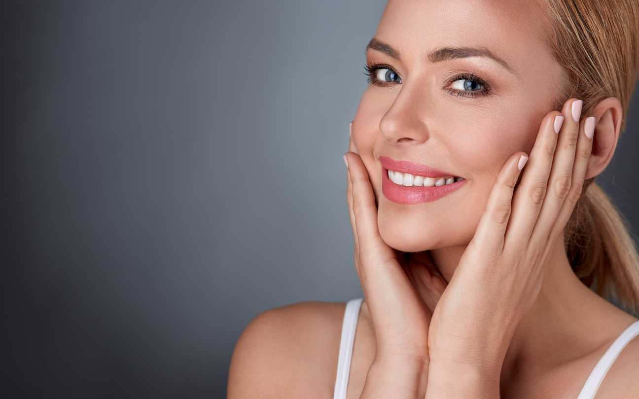 Smiling woman enjoying in her healthy skin